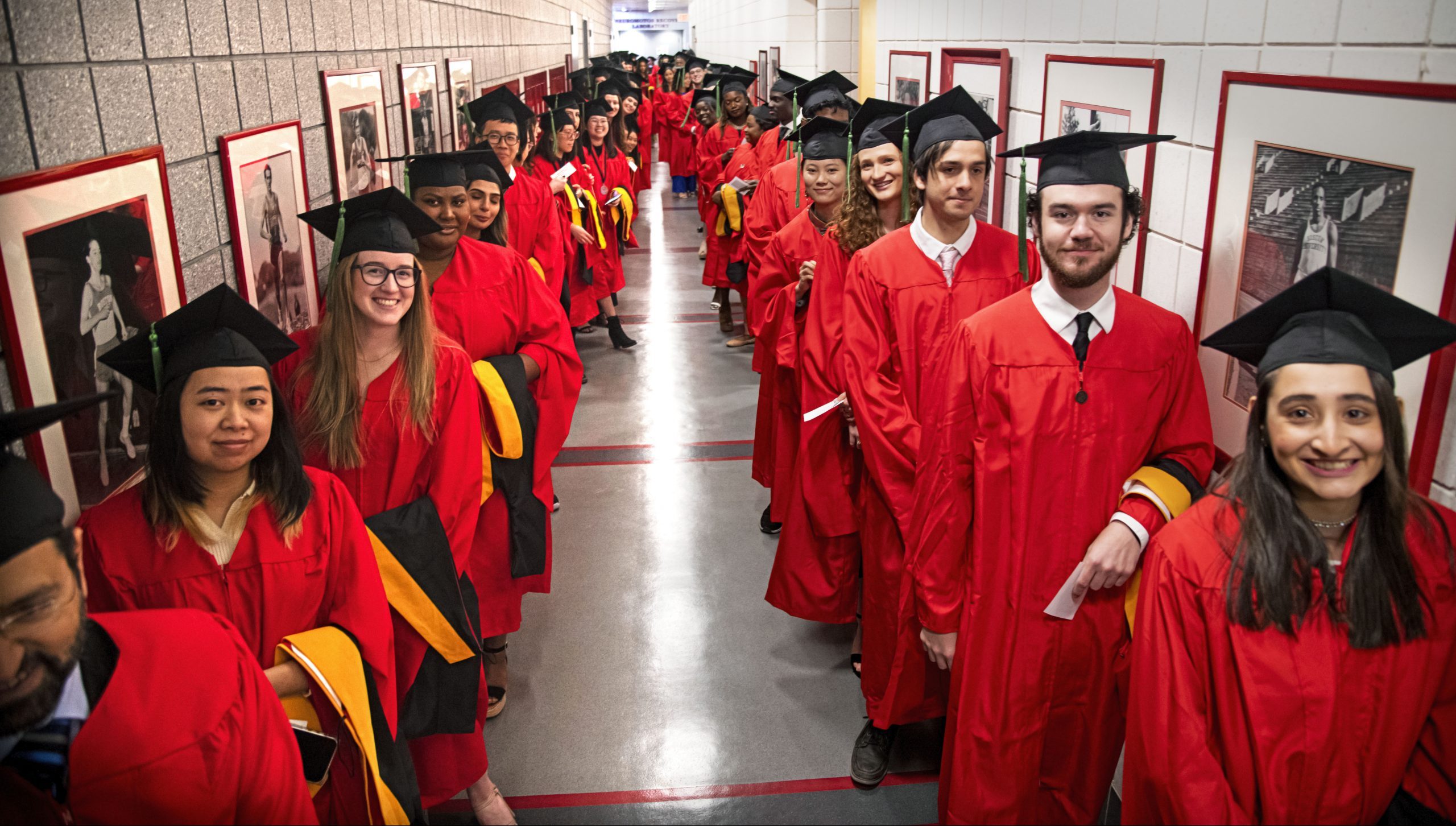 Two lines of GMS masters students lining up before convocation ceremony