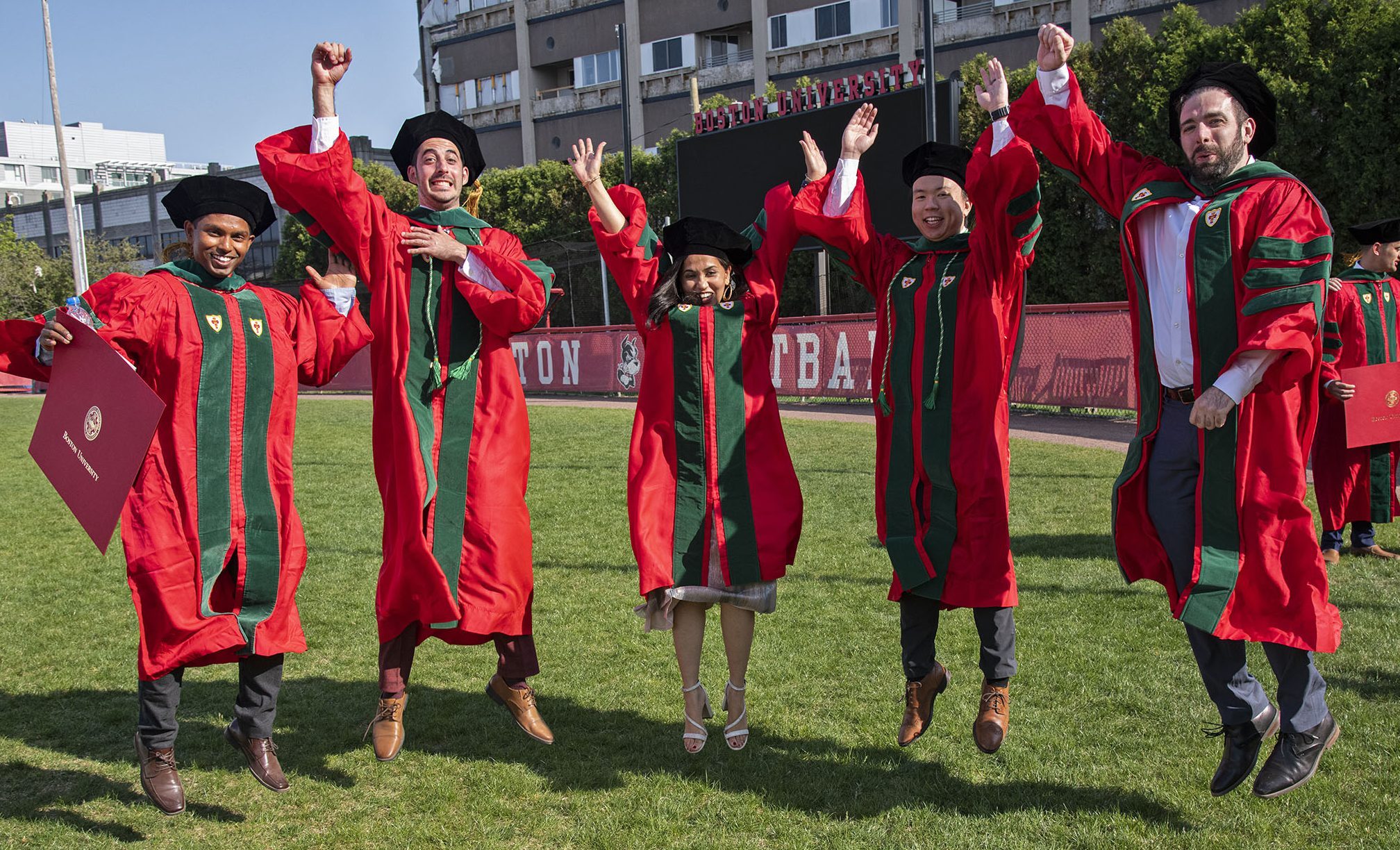 MD grads jumping on field after convocation ceremony