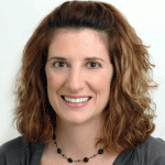 head and shoulders shot of white woman, shoulder length brown hair, smiling 