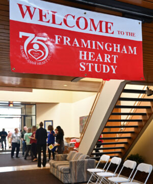Red and white welcome to the Framingham Heart Study sign hanging from a ceiling