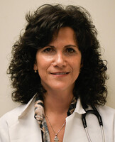 head and shoulders of woman with dark shoulder length curly hair with stethescope around her neck