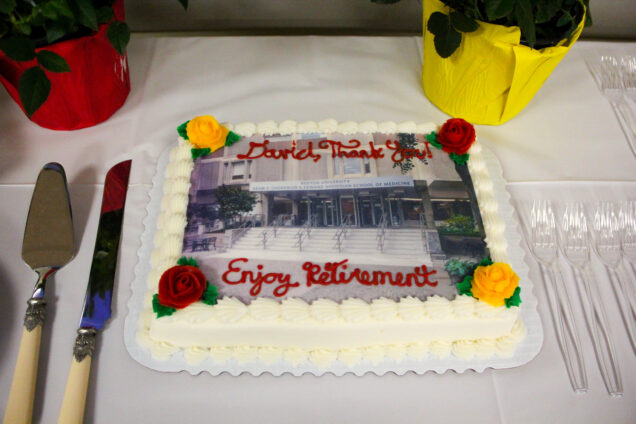 Sheet cake on table featuring a photo taken by David of the front of the Instructional building