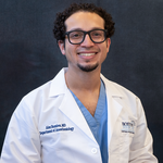 head and shoulders of Dr. Ramirz in scrubs and whitecoat