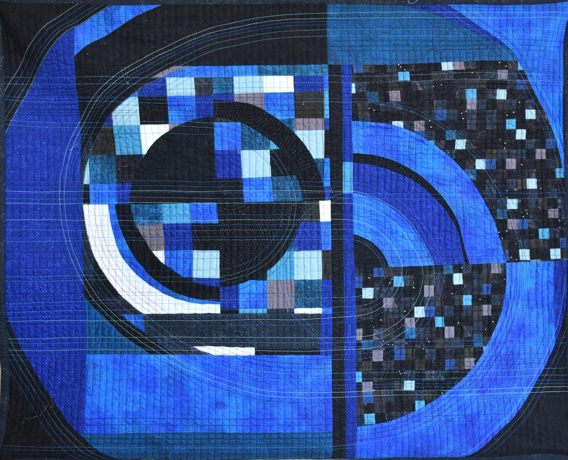 Quilt in shades of blue, black and white