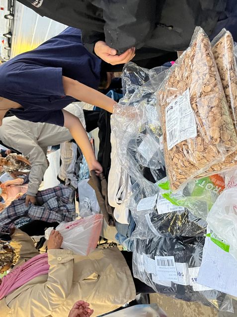 student volunteers give out food and clothes on a Thursday with the Outreach Van Project