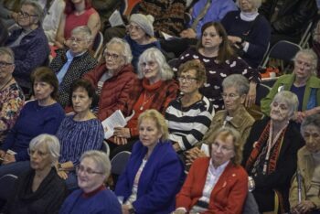 large group of audience members listening to presentations