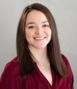 head and shoulders shot of Marielle Baldwin with long straight brown hair, burgandy top, smiling