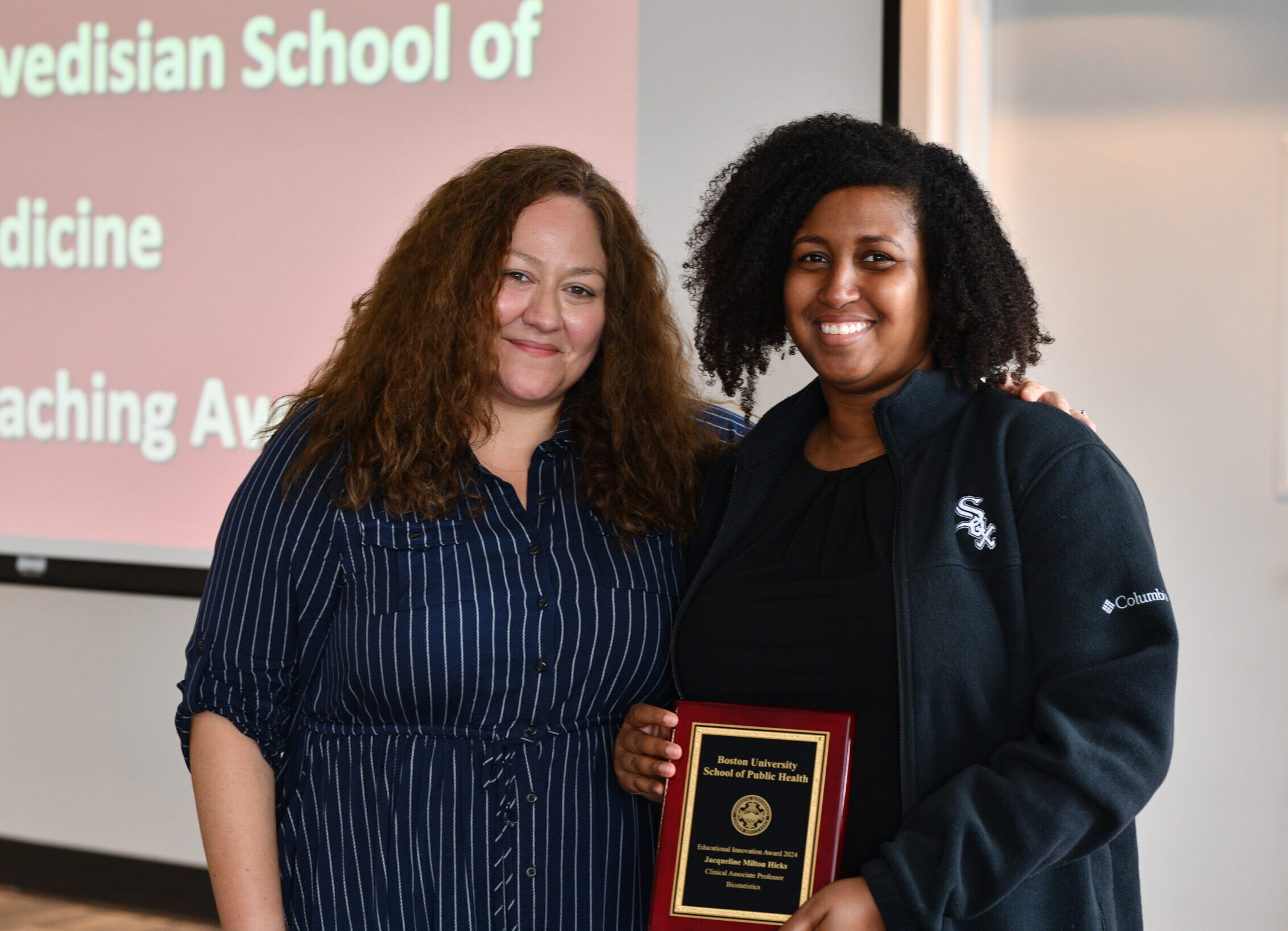 Assistant Dean Velez presenting Associate Professor Hicks with award