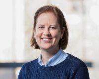 head and shoulders of dr. day wearing light blue shirt, dark blue sweater