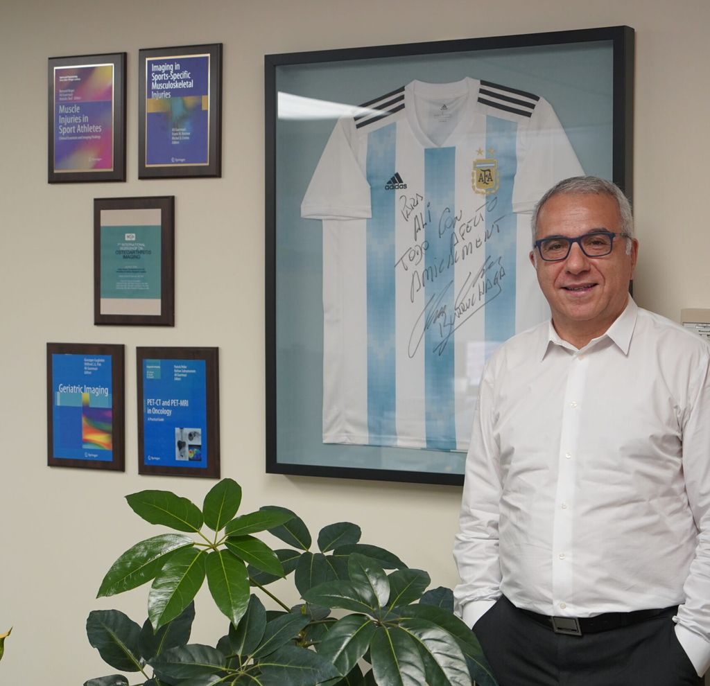 Ali Guermazi standing in his office at the West Roxbury VA Medical Center.