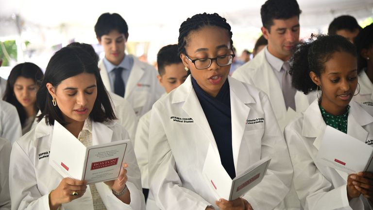 Students reading hippocratic oath for the first time.