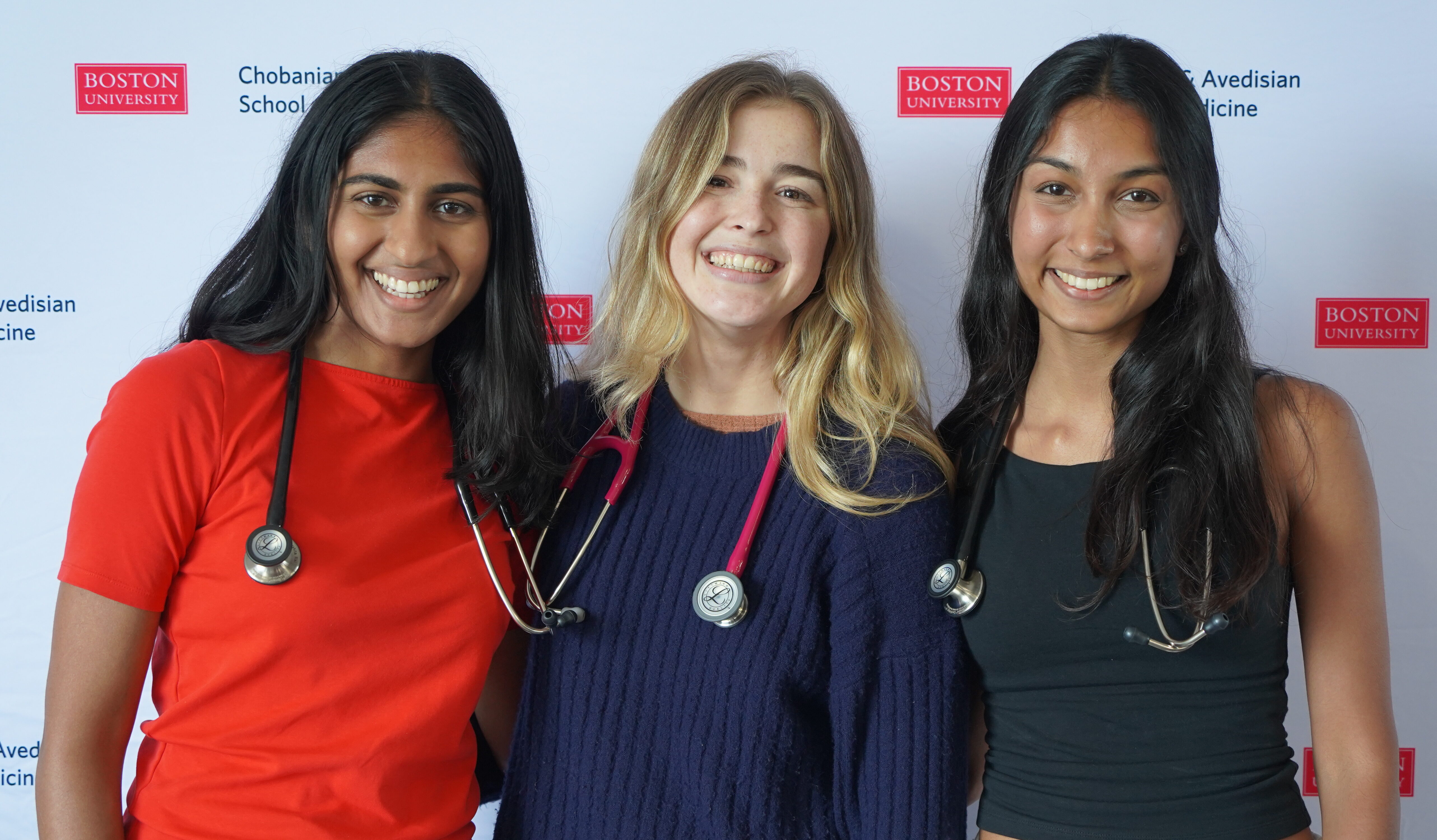 Three first year students posing with their new stethoscopes