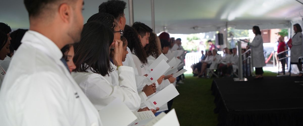 Students at White Coat Ceremony looking at stage.