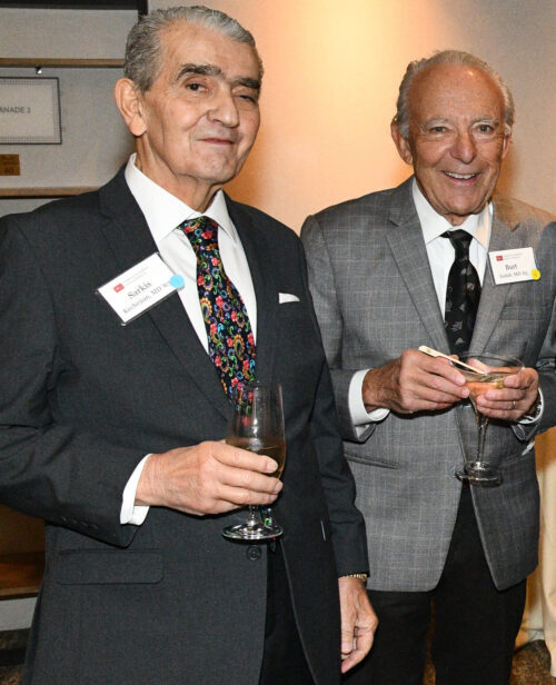 Sarkis Kechejian and Burton Golub standing together smiling