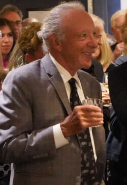Scholarship donor Burton Golub standing in a crowd of people smiling broadly
