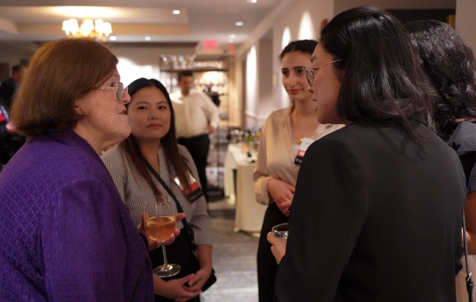 Donor Elizabeth Brown r) talking with a small group of scholarship recipients