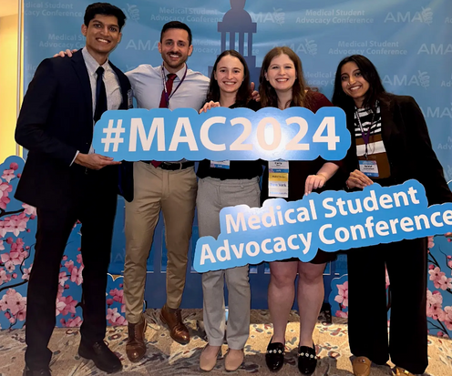 Five individuals at the Medical Student Advocacy Conference holding a #MAC2024 sign.