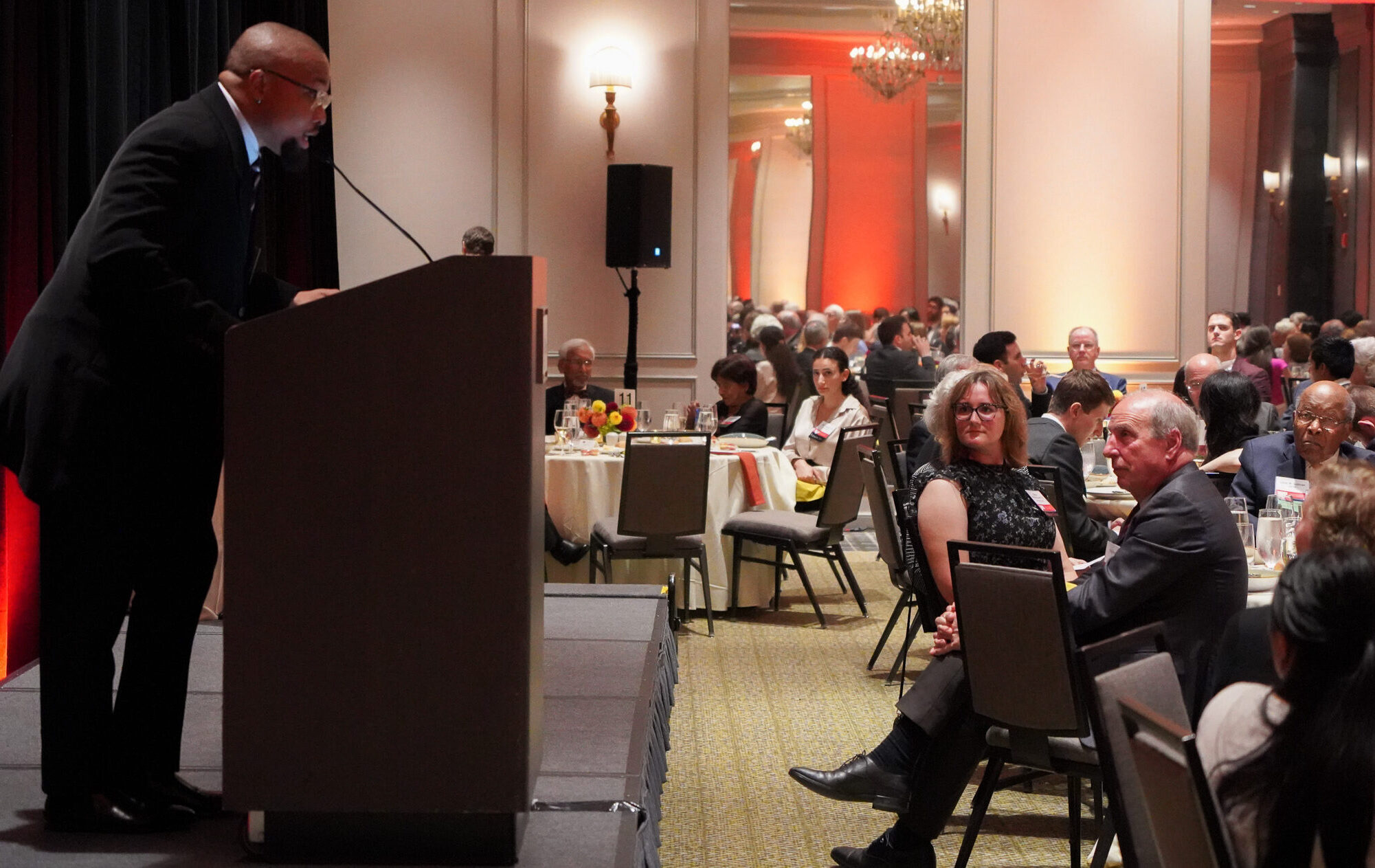 Medical student Nnaemeka Chukwudalu Nwoke addresses the audience from a podium at the scholarship dinner