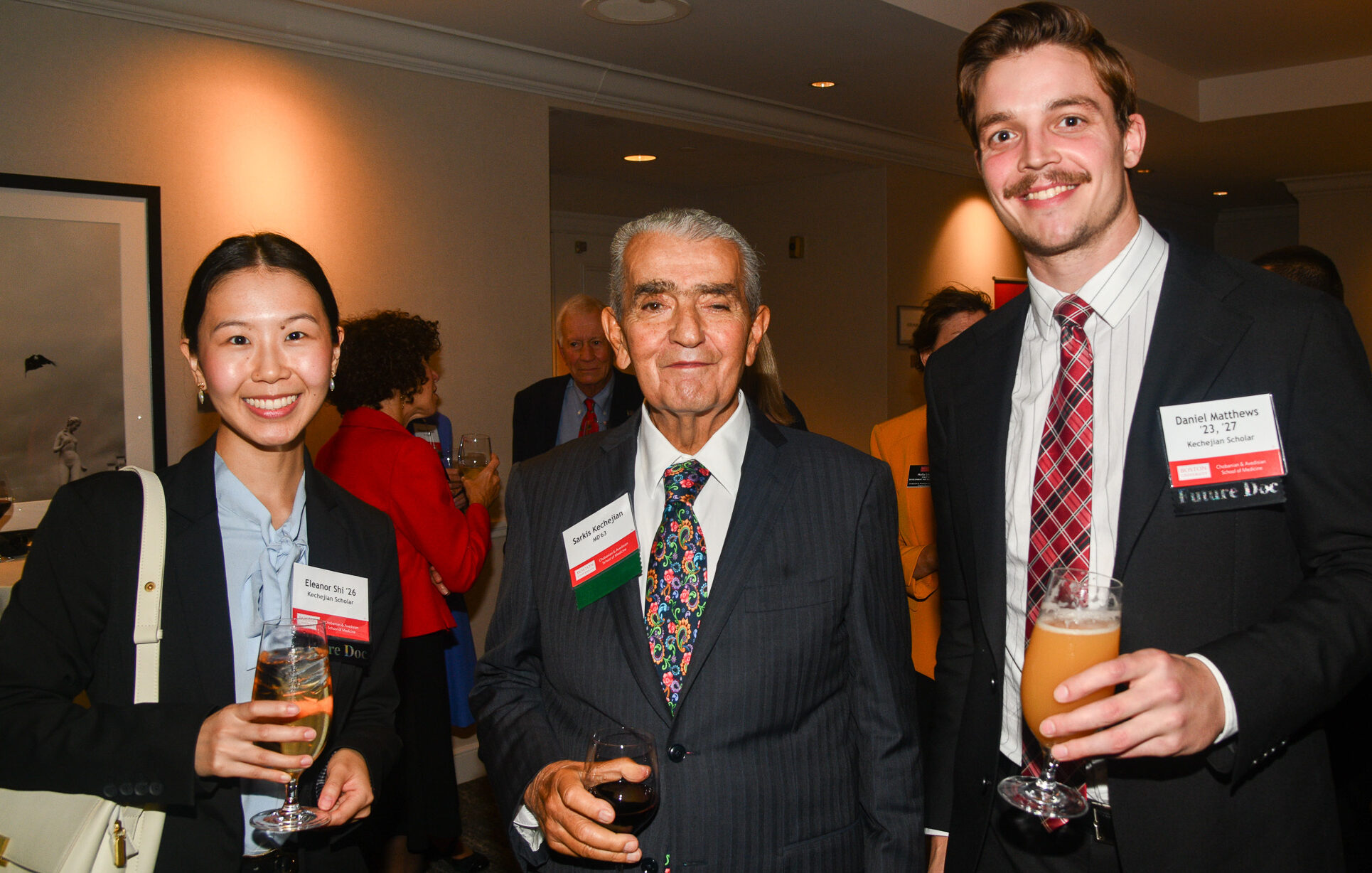 Donor Sarkis Kechejian standing between two scholarship recipients