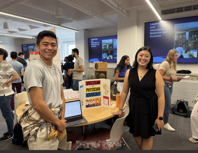 Two students representing the Spectrum of Physician Advocacy Student Group at fair.