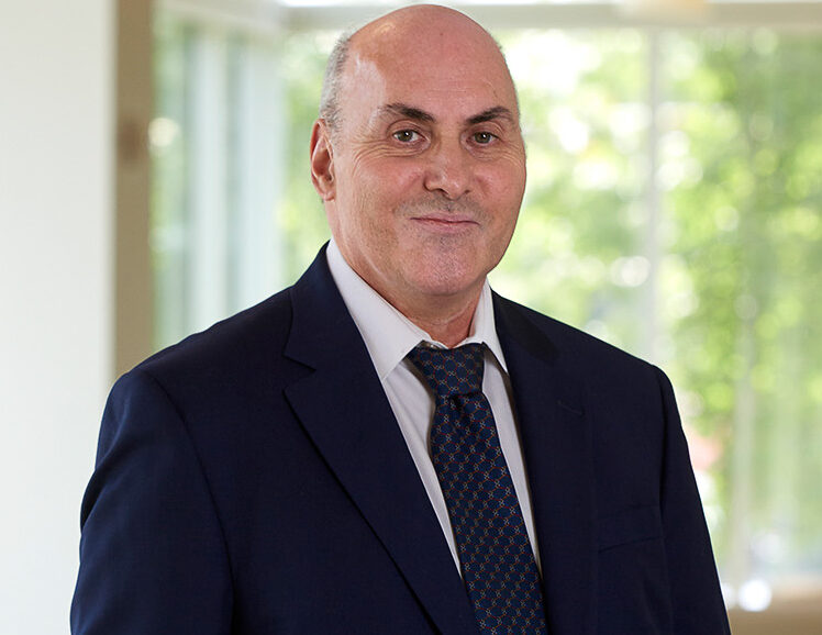 Nobel prize winner Drew Weissman in a dark blue suit.