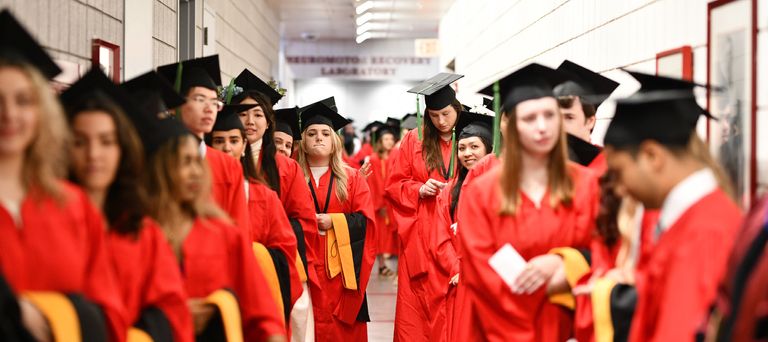 Master’s degree candidates line up before the ceremony.