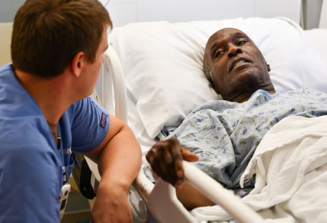 Second-year med student Jackson Wallner talks with retired Army drill sergeant Robert “Rick” Jones.