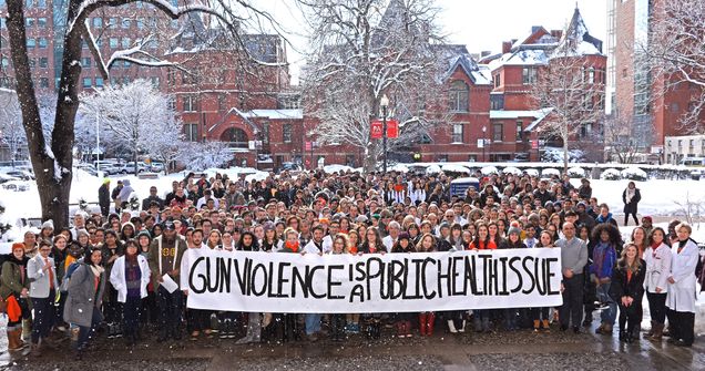Dean Antman, pictured in front row far right, stands with BU Medical Campus students, faculty, and staff on March 14, 2018, to demonstrate solidarity with victims of gun violence.