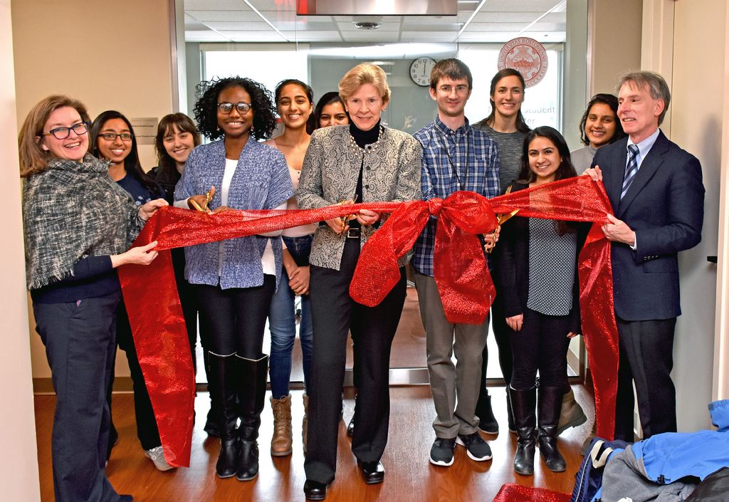 Dean Antman, center, cuts the ribbon on the dedicated medical student lounge and study space in January 2018.