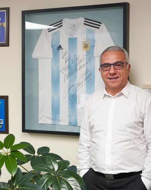 Guermazi, chief of radiology at the VA Boston Healthcare System, in his office at the West Roxbury VA Medical Center. The framed soccer jersey behind him was signed by Jorge Burruchaga, who scored the winning goal for Argentina in the 1986 World Cup Final.