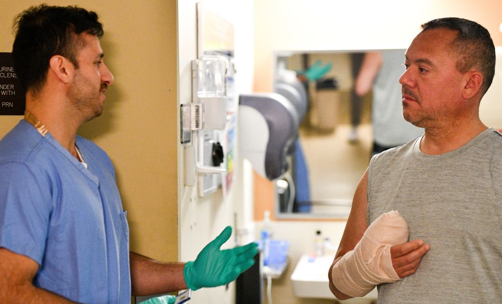 Second-year med student Juan Guerrero discusses recovery from a severe hand injury with former Navy rescue swimmer Joey Gupin.