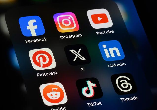 A close-up of a phone shows a grid listing of popular social media apps on screen.