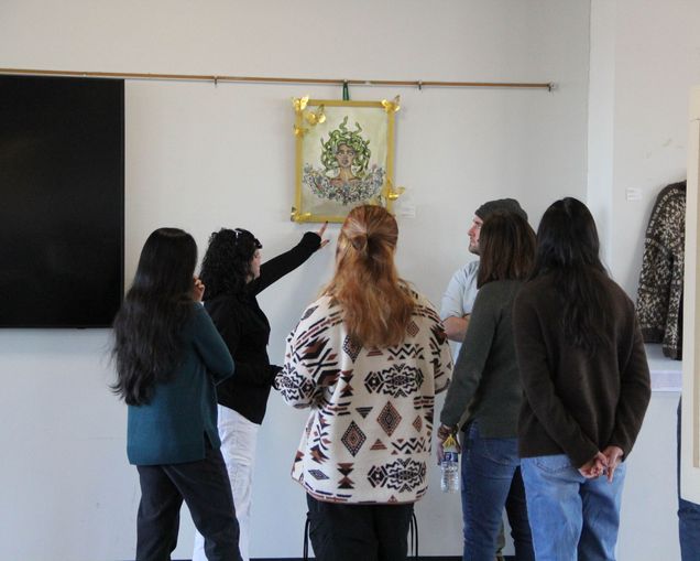 Students gstudents admiring art hanging on wall