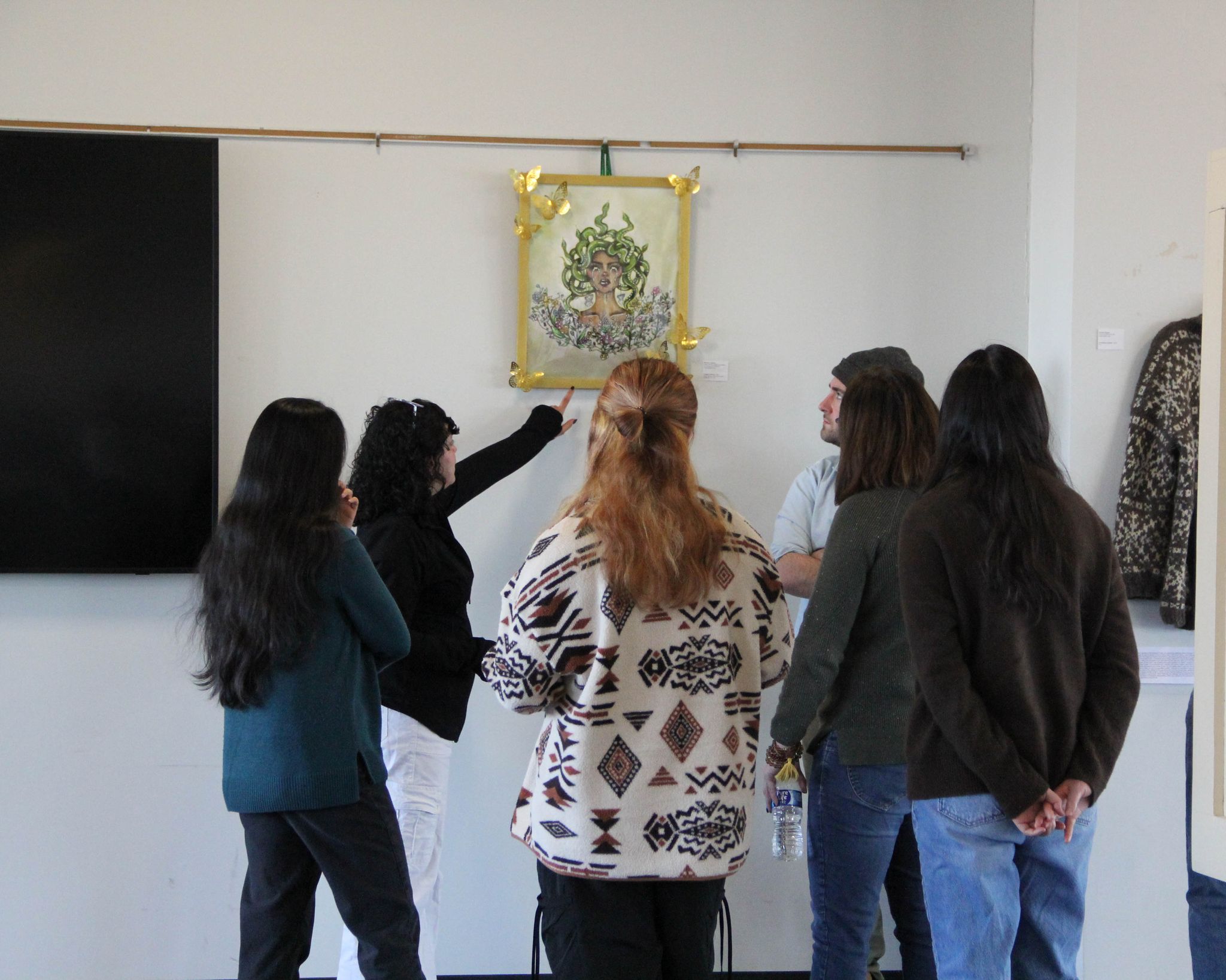 Students gstudents admiring art hanging on wall