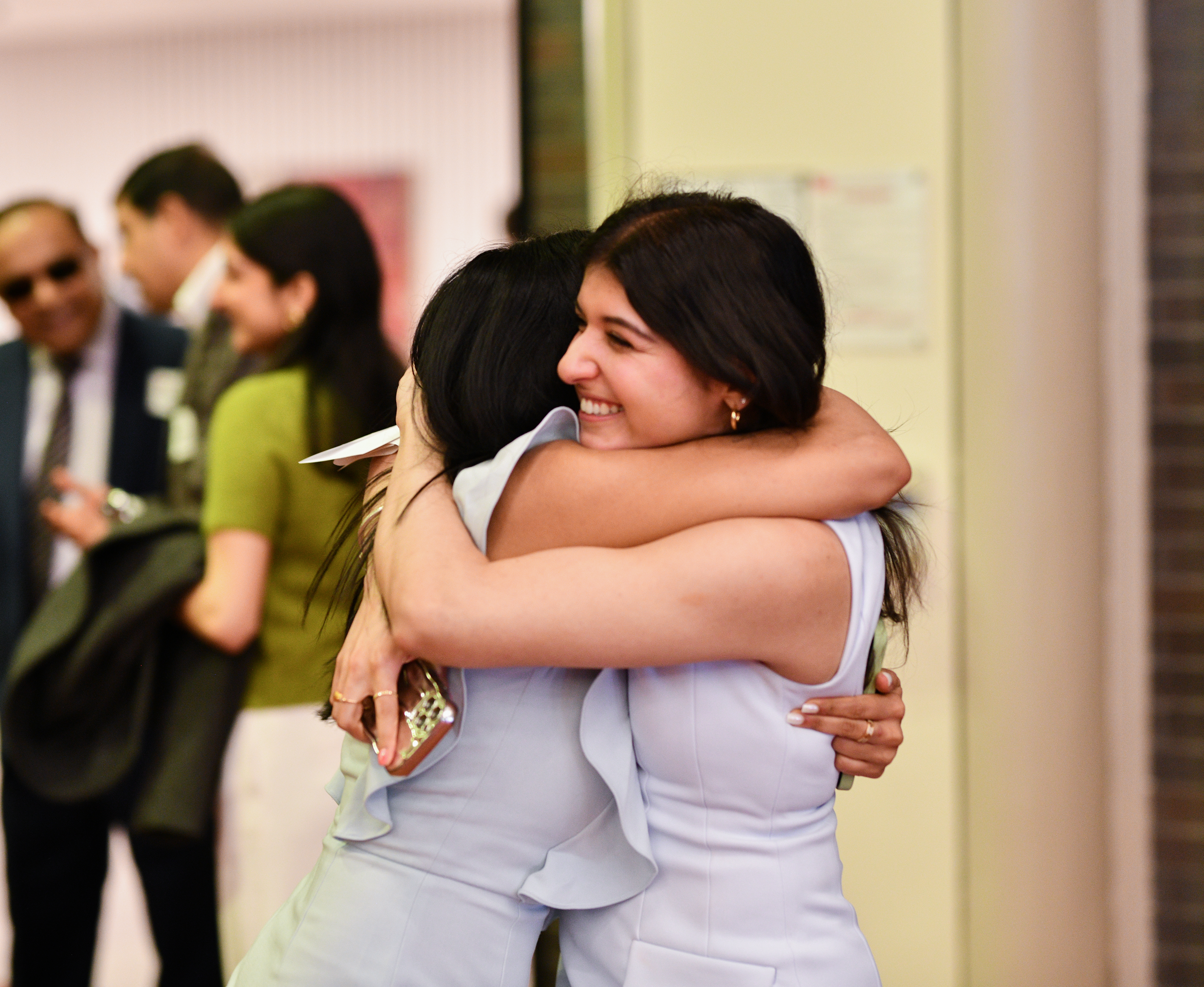 Two women embracing, celebrating Match Day