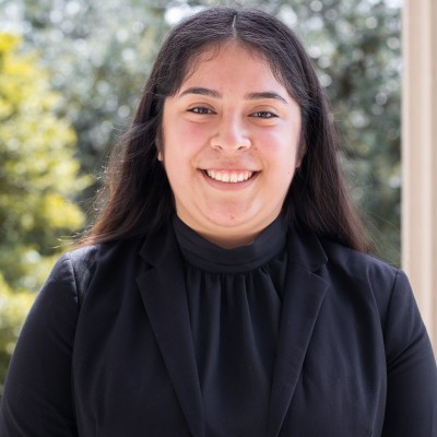 head and shoulders image of Teresa Acosta, long straight dark hair, broadly smiling