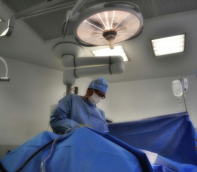 Doctor in operating room with blue scrubs