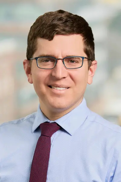 head and shoulders of Ariel Marks wearing light blue collared shirt, eyeglasses