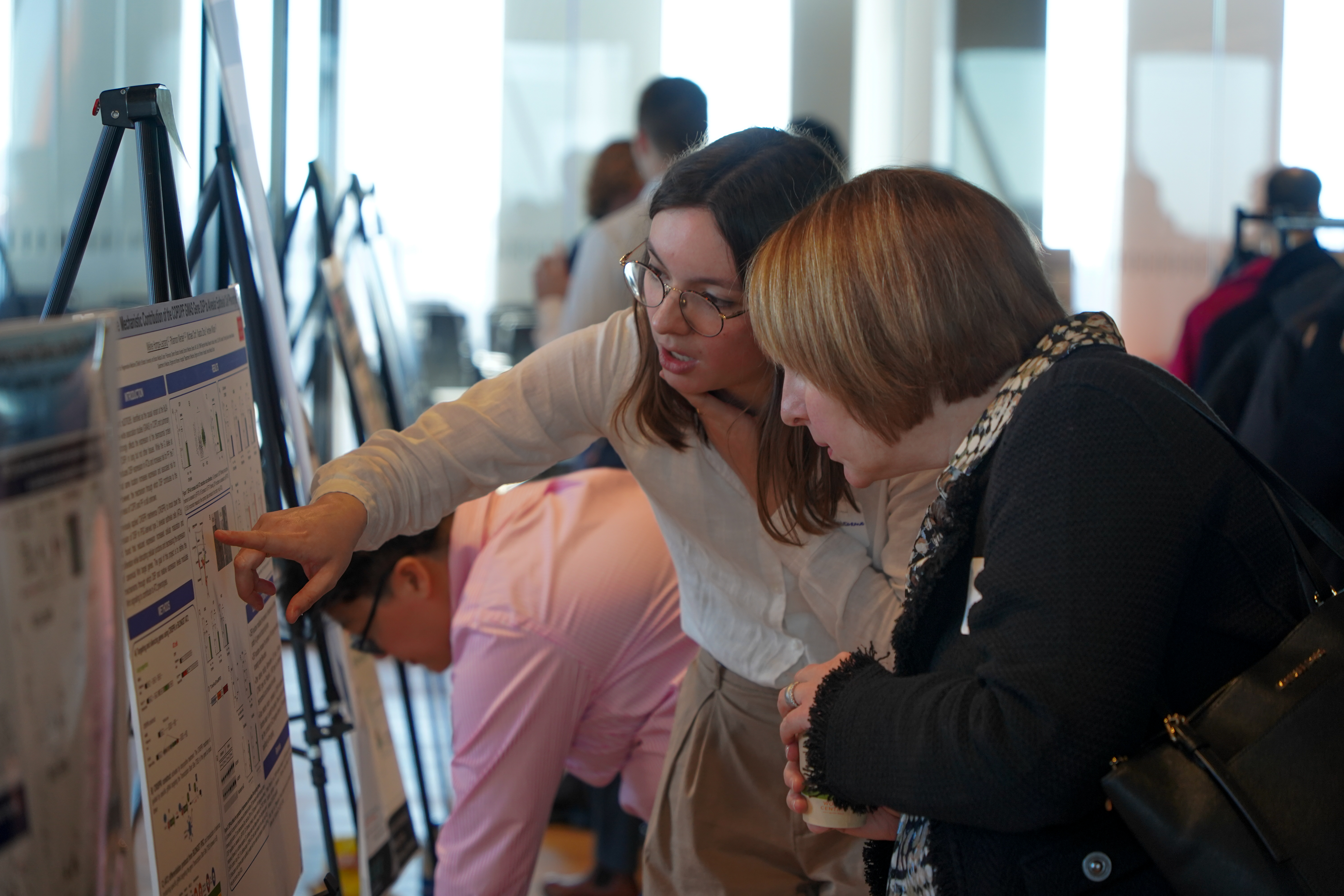 Méline Homps-Legrand, PhD, explains her research at the Translational Science Symposium poster session