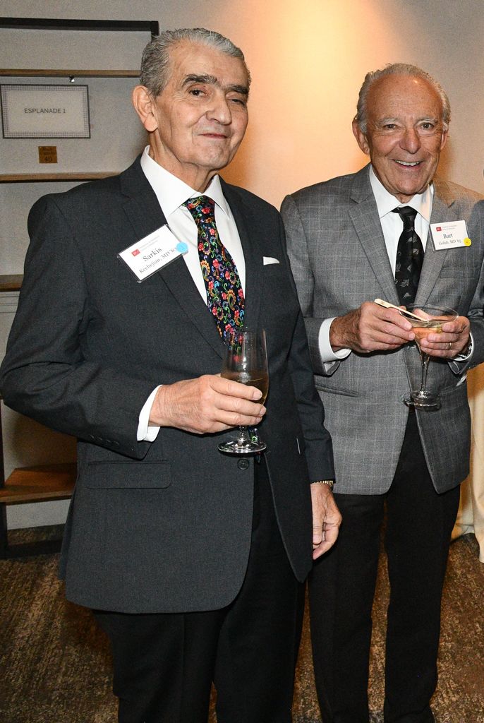 Sarkis Kechejian and Burton Golub standing together smiling