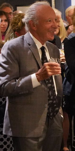 Scholarship donor Burton Golub standing in a crowd of people smiling broadly