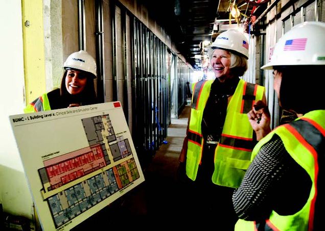 Dean Antman, center, reviews the plans for the new clinical skills and simulation center during a construction walk-through of the space.