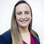 Elizabeth Duffy long blond hair, dark suit jacket, pink shirt