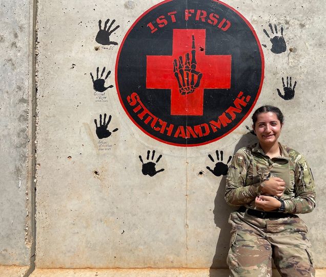 Vejar wearing army camo and holding a kitten