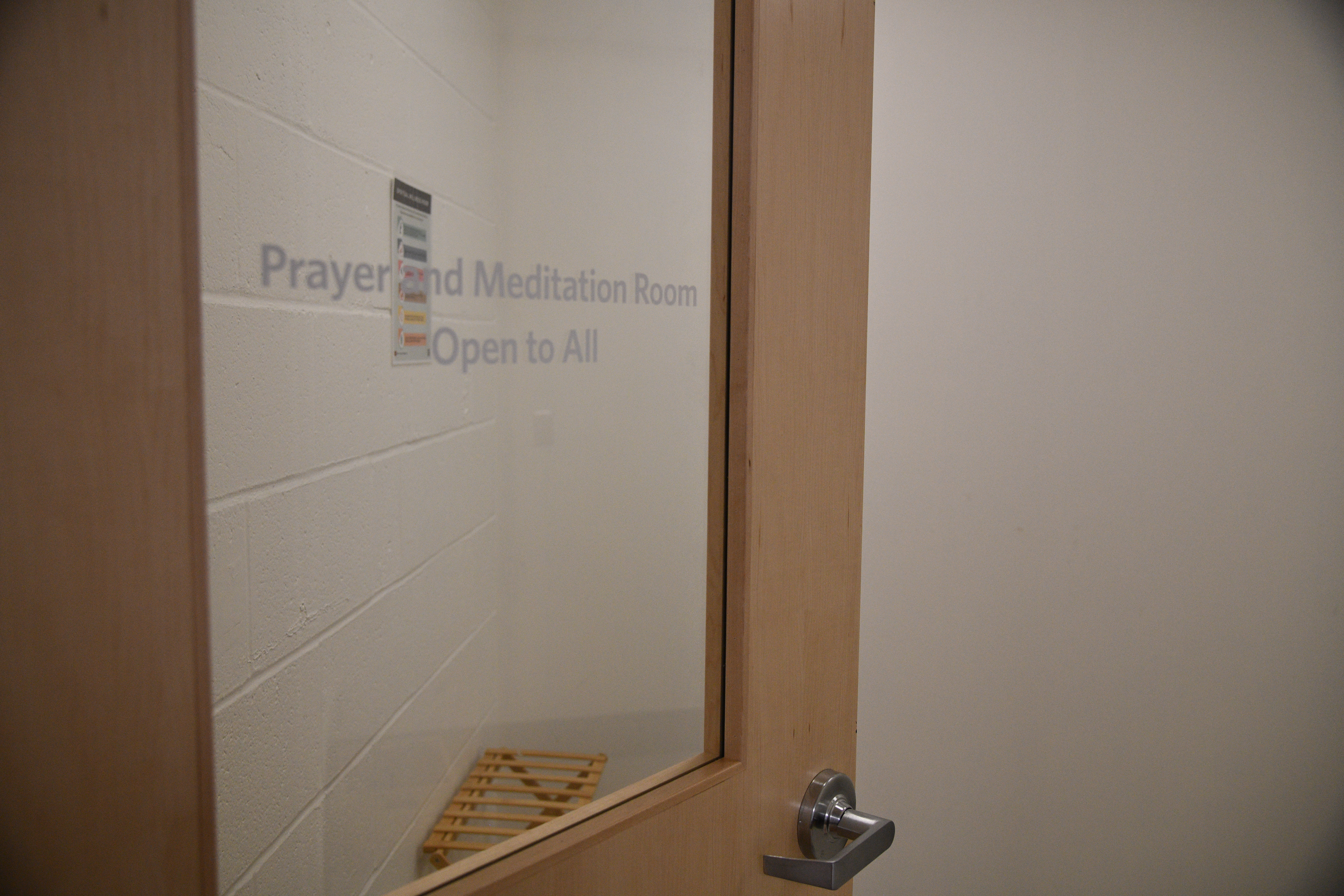 view of meditation room through glass panel door that states paryer and Meditation Room