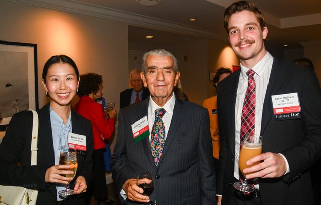 Donor Sarkis Kechejian standing between two scholarship recipients