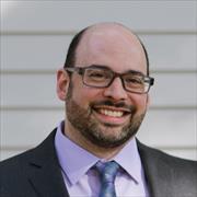 Head and shoulders of Michael Esterman eyeglasses, smiling broadly