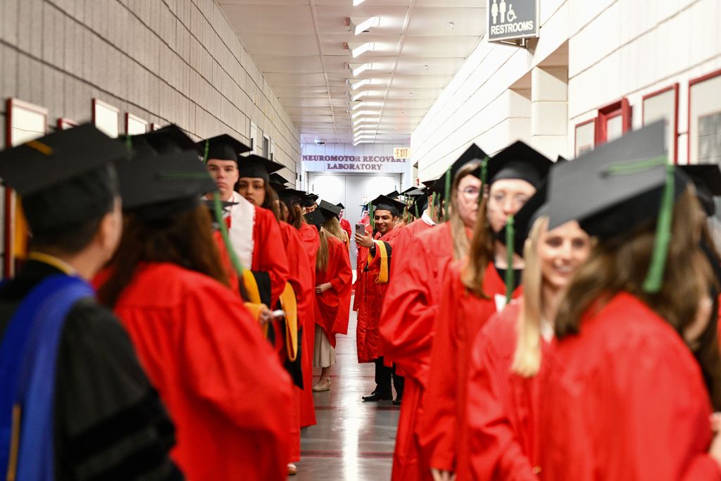 GMS students in cap and gown lining up before convocation ceremony