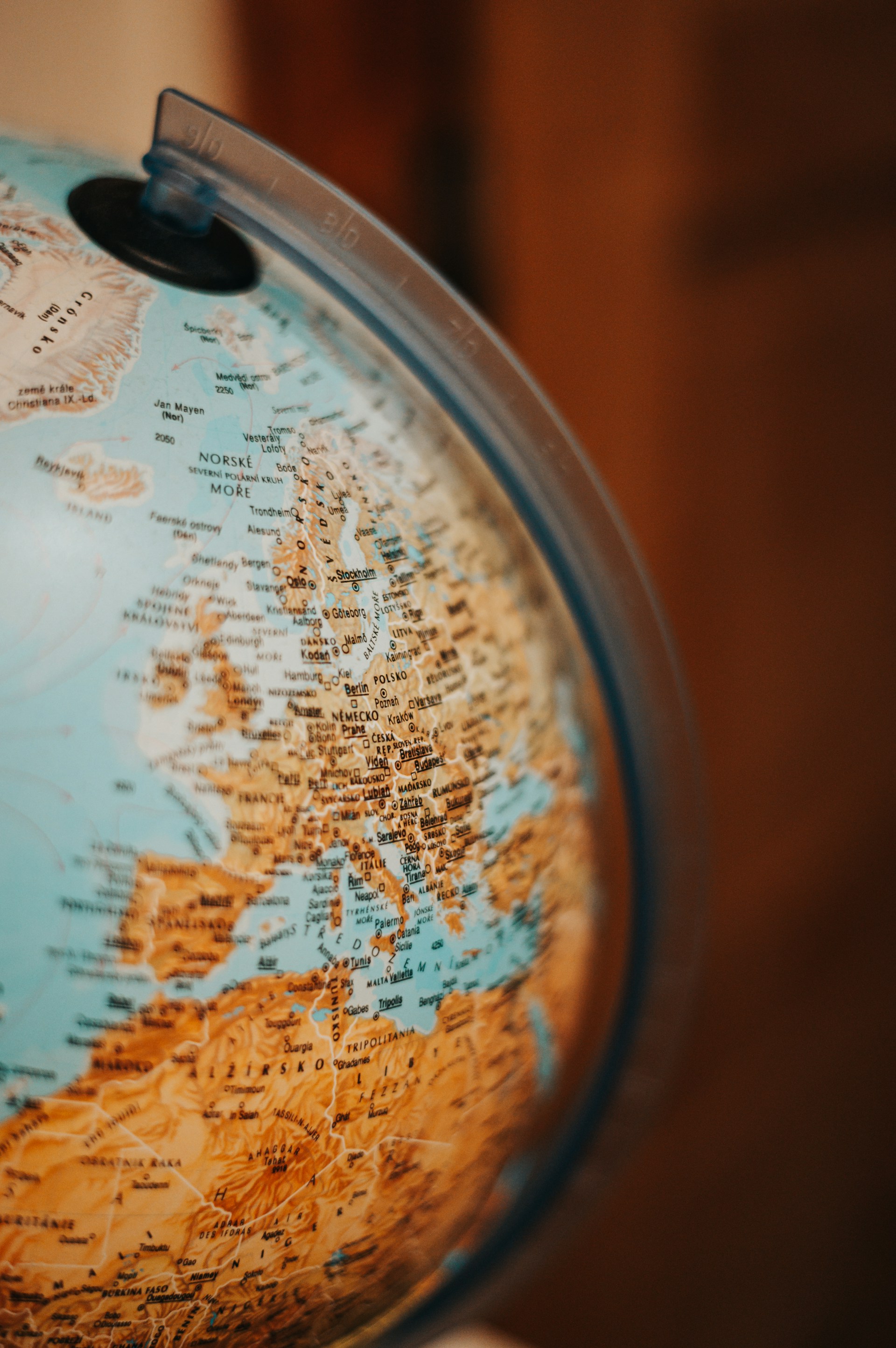 colorful globe againsta a wood wall background