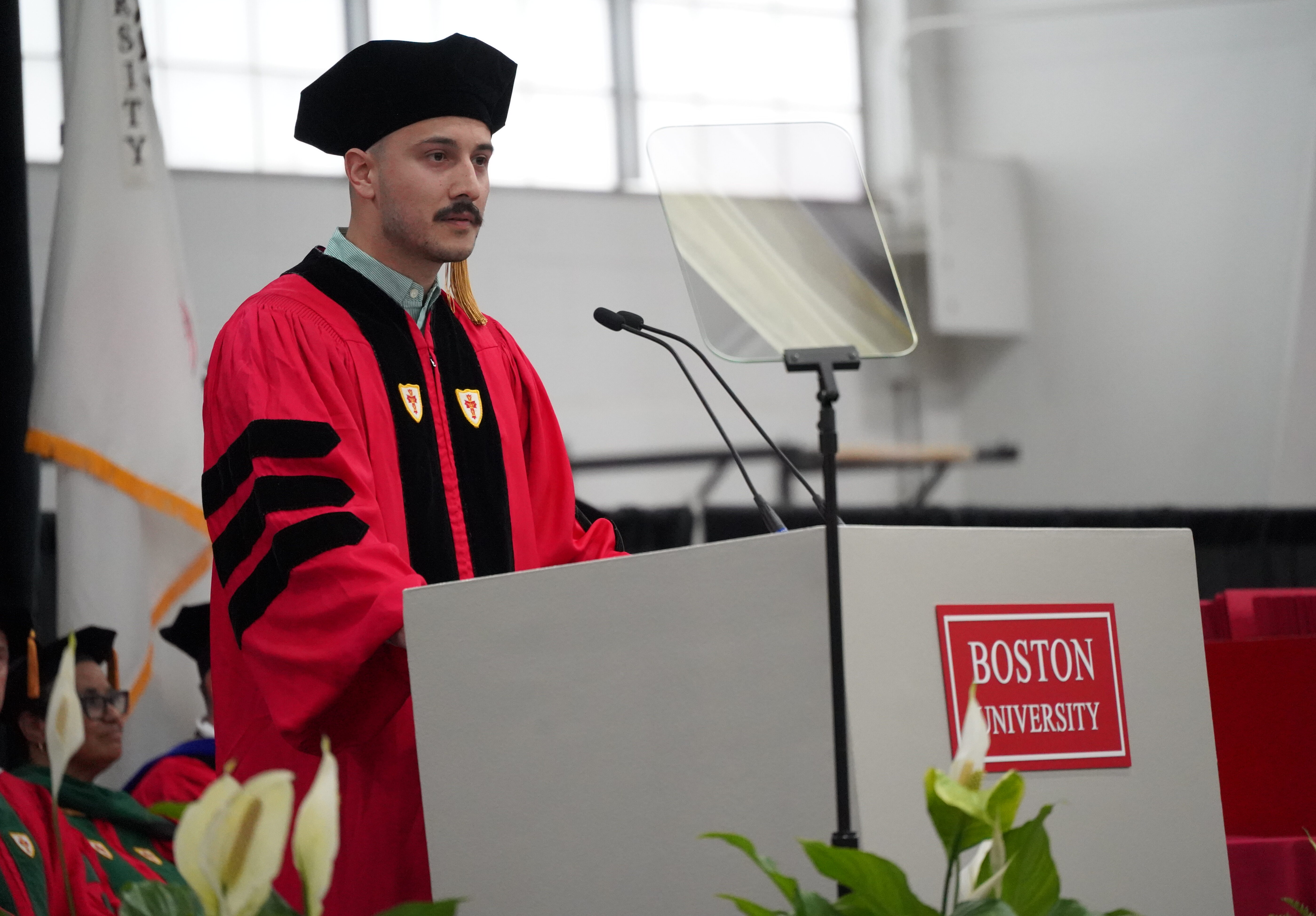 Jhonatan Henao Vasquez, PhD’25 stands at podium addressing convocation